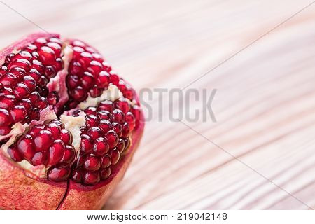 Big red pomegranate on the wooden board. Ripe granet fruit.