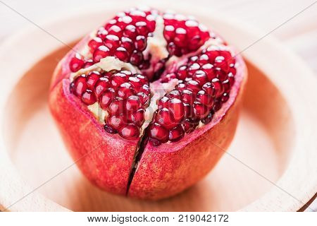 Big red pomegranate on the wooden board. Ripe granet fruit.