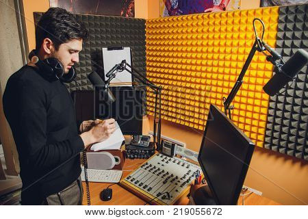 Microphone in radio studio and presenter on background
