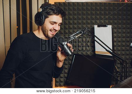 Microphone in radio studio and presenter on background