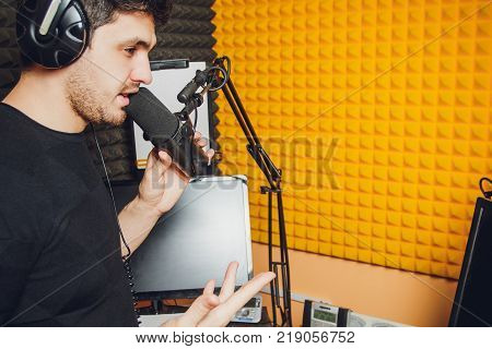 Microphone in radio studio and presenter on background