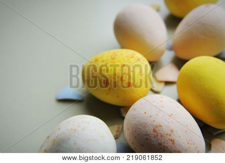 Easter chocolate eggs on plate. Different colors. Easter desserts.