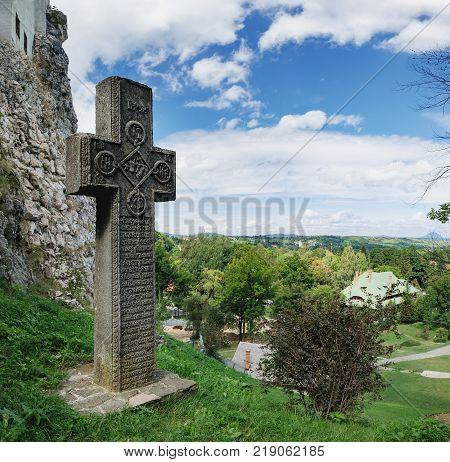 Bran, Brașov, Romania - September 7, 2017: Medieval stone cross with religious symbols at the entrance to the Bran or Dracula Castle in Transylvania, Romania.