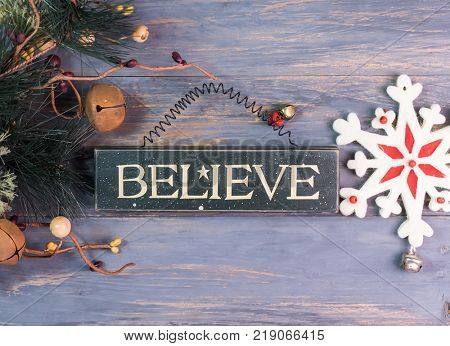 beleve written on wooden background with snowflake