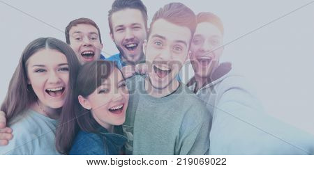 Group of happy young teenager students taking selfie photo isolated on white background