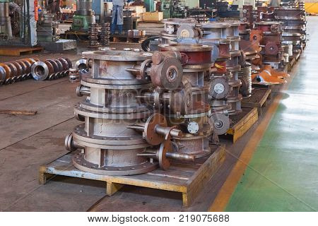 Heap of valve bodies spare parts prapared for mashining in factory. Casting carbon steel boides. Forging stainless still parts. Industrial background from part of valves for power oil or gas industry