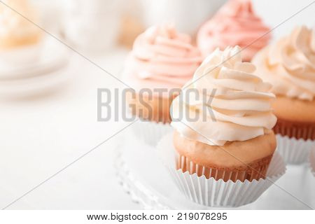 Tasty cupcakes on stand