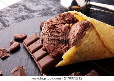 chocolate ice cream scoops with pieces of chocolate and waffle cones