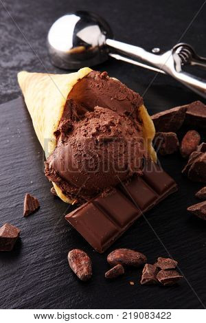 chocolate ice cream scoops with pieces of chocolate and waffle cones
