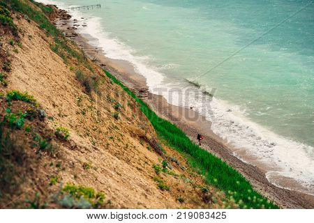 a sharp hillside ending in a troubled sea