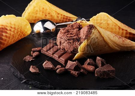 chocolate ice cream scoops with pieces of chocolate and waffle cones