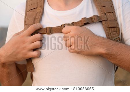 A Young Man Demonstrates Fastex Buckle In Action From The Waist Belt Of A Backpack