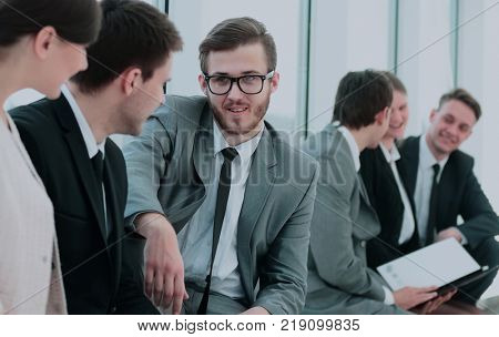 business team with laptop and documents sitting in the lobby bef