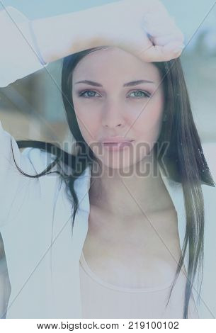 business woman looking thtough window in the office