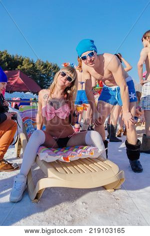 Novokuznetsk, Kemerovo region, Russia - 23 Feb, 2017 : White beaches of Siberia is an enterteiment activity where people playing beach games dressed in bikini in winter. Woman in bikini and a man
