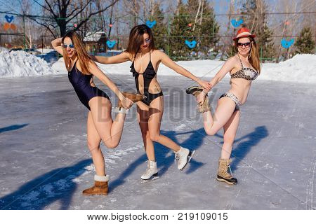 Novokuznetsk, Kemerovo region, Russia - 23 Feb, 2017 : White beaches of Siberia is an enterteiment activity where people playing beach games dressed in bikini in winter. Women in bikini on ice skates