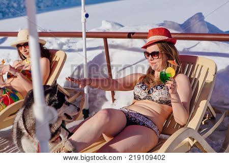 Novokuznetsk, Kemerovo region, Russia - 23 Feb, 2017 : White beaches of Siberia is an enterteiment activity where people playing beach games dressed in bikini in winter. Woman in bikini with cocktail