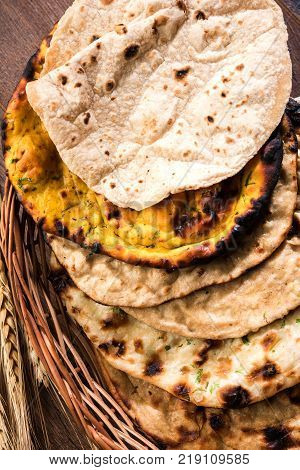 Assorted Indian Bread Basket includes chapati, tandoori roti or naan, paratha, kulcha, fulka, missi roti
