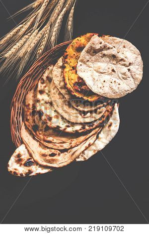 Assorted Indian Bread Basket includes chapati, tandoori roti or naan, paratha, kulcha, fulka, missi roti