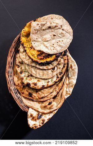 Assorted Indian Bread Basket includes chapati, tandoori roti or naan, paratha, kulcha, fulka, missi roti