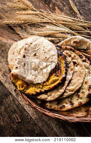 Assorted Indian Bread Basket includes chapati, tandoori roti or naan, paratha, kulcha, fulka, missi roti