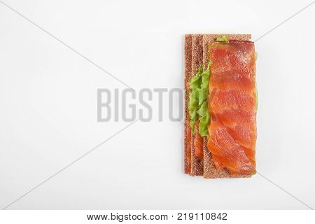 Low caloric open sandwich with salmon. Isolated on white background.