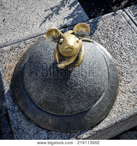 Klaipeda, Lithuania - August 16, 2017: Beautiful little magic mouse, Klaipeda, Lithuania. One of Klaipeda's charming, small street sculptures Golden Mouse
