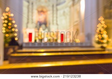 Defocused church interior blur abstract background with Christmas trees