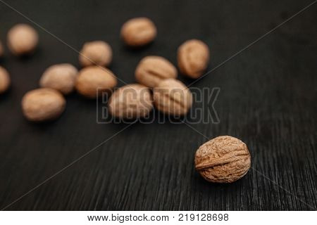 Lots Of Fresh Nuts On A Black Wooden Background. Best Practices For Designer