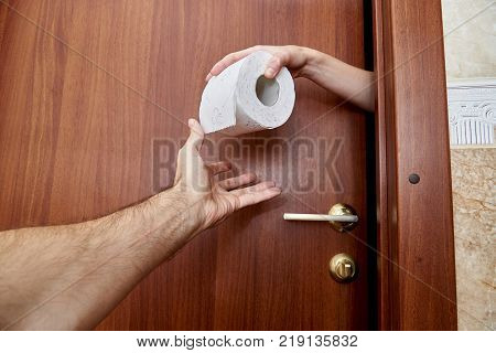 Hand delivers toilet paper to the other hand