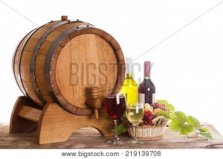 Grapes and bottels of wine near the wooden barrel. Glasses of wine on the table, concept of winery - red and white