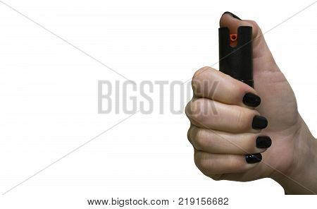 Womens hand with black bottle of pepper spray isolated on white background with copyspace