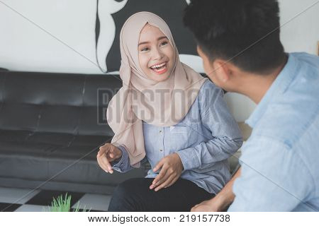 happy young muslim friend laughing together and having a good talk in a coffeshop