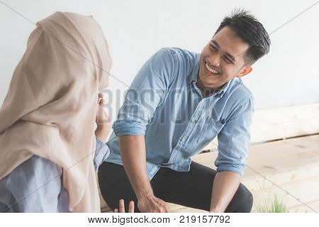 happy young muslim friend laughing together and having a good talk in a coffeshop