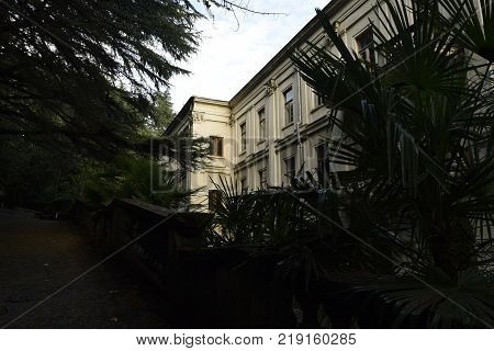 white hull of the famous sanatorium of the Stalin era, framed by evergreen trees, is now abandoned and slowly decaying