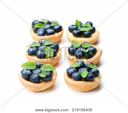 puff pastry stuffed with soft curd with blueberries on white background