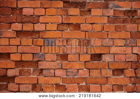 The texture of an old wheatered red brick wall, background
