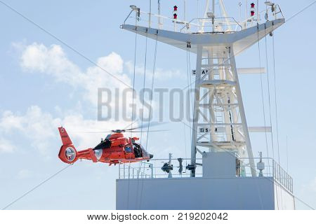 NORTH ATLANTIC OCEAN-DECEMBER 12, 2017: The United States Coast Guard engages in a medical rescue from a ship in the North Atlantic Ocean.