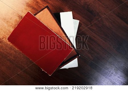 one book ontop of another book stacked ontop of each other against a wooden background