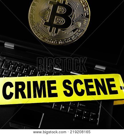 bitcoin on a laptop with crime scene tape
