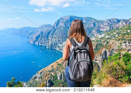 Woman backpacker at Path of Gods on Tyrrhenian sea Amalfi coast Italy