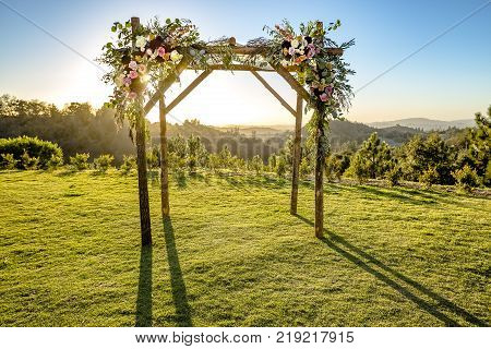 Outdoor sunset view of a Jewish traditions wedding ceremony. Wedding canopy chuppah or huppah .