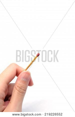 Hand holding a match on white background.