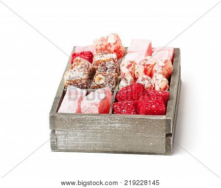 Assortment turkish delight in wooden box isolated on white
