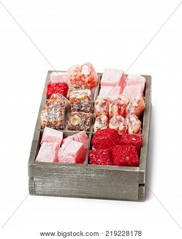 Assortment turkish delight in wooden box isolated on white