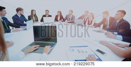 business partners gathered round the table and prepared to discu