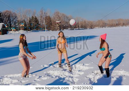 Novokuznetsk, Kemerovo region, Russia-23 Feb, 2017: White beaches of Siberia is an enterteiment activity where people playing beach games dressed in bikini in winter. Women playing volleyball on snow