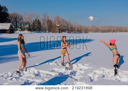 Novokuznetsk, Kemerovo region, Russia-23 Feb, 2017: White beaches of Siberia is an enterteiment activity where people playing beach games dressed in bikini in winter. Women playing volleyball on snow