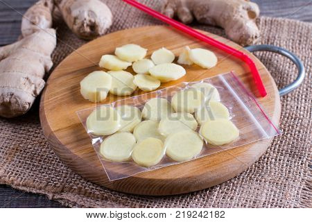 Cutting board with ginger root sliced. Freezing food.