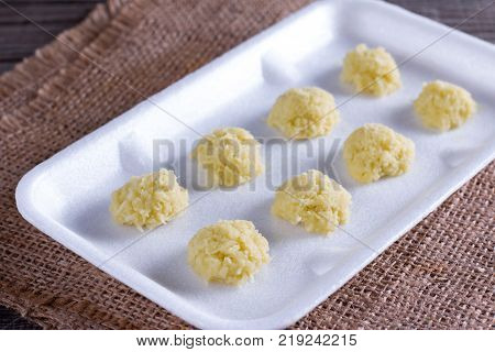 Frozen grated ginger on a wooden table